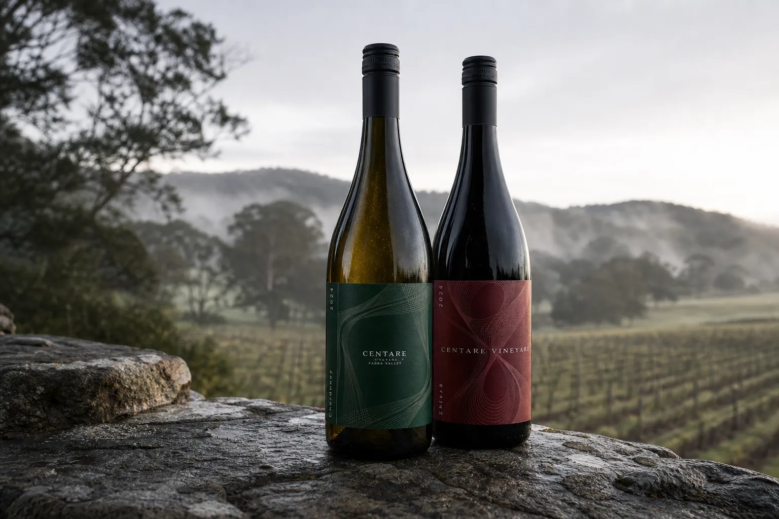 Two CENTARE VINEYARD bottles standing on wet stone with misty Yarra Valley vines in the background