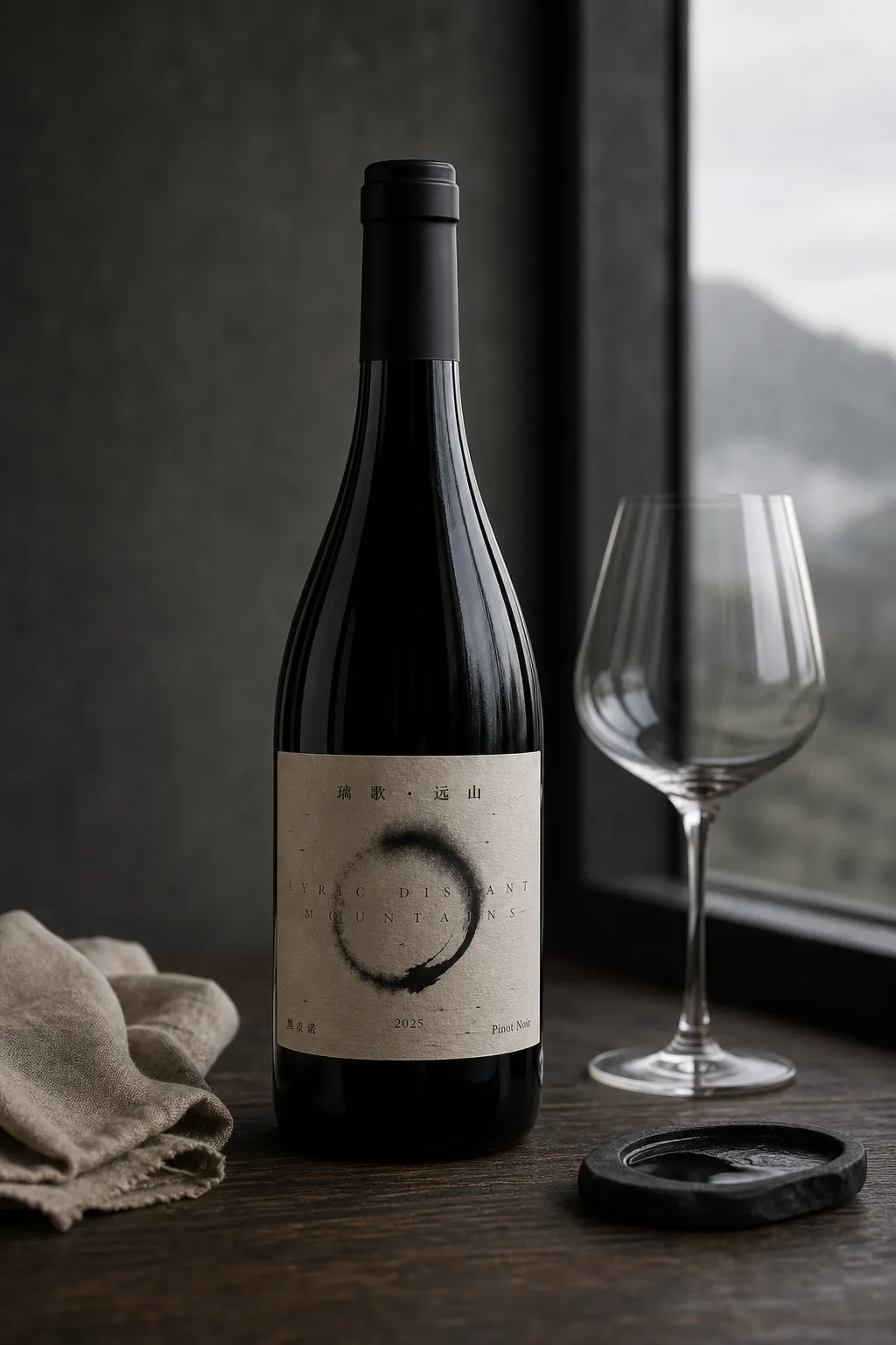 Lige Yuanshan Pinot Noir bottle and empty glass in a quiet grey mountain interior