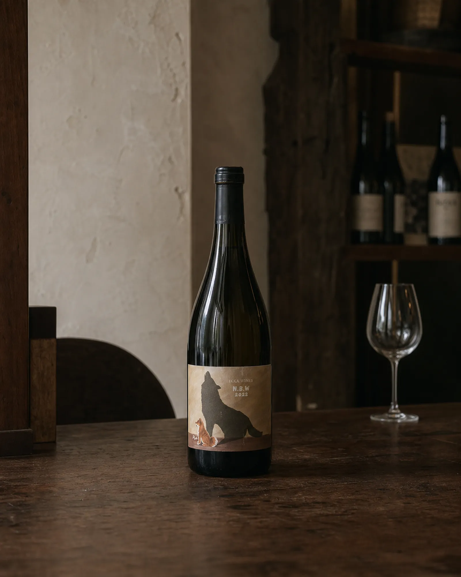 IKKA WINES N.B.W bottle in low light with a dark animal silhouette label