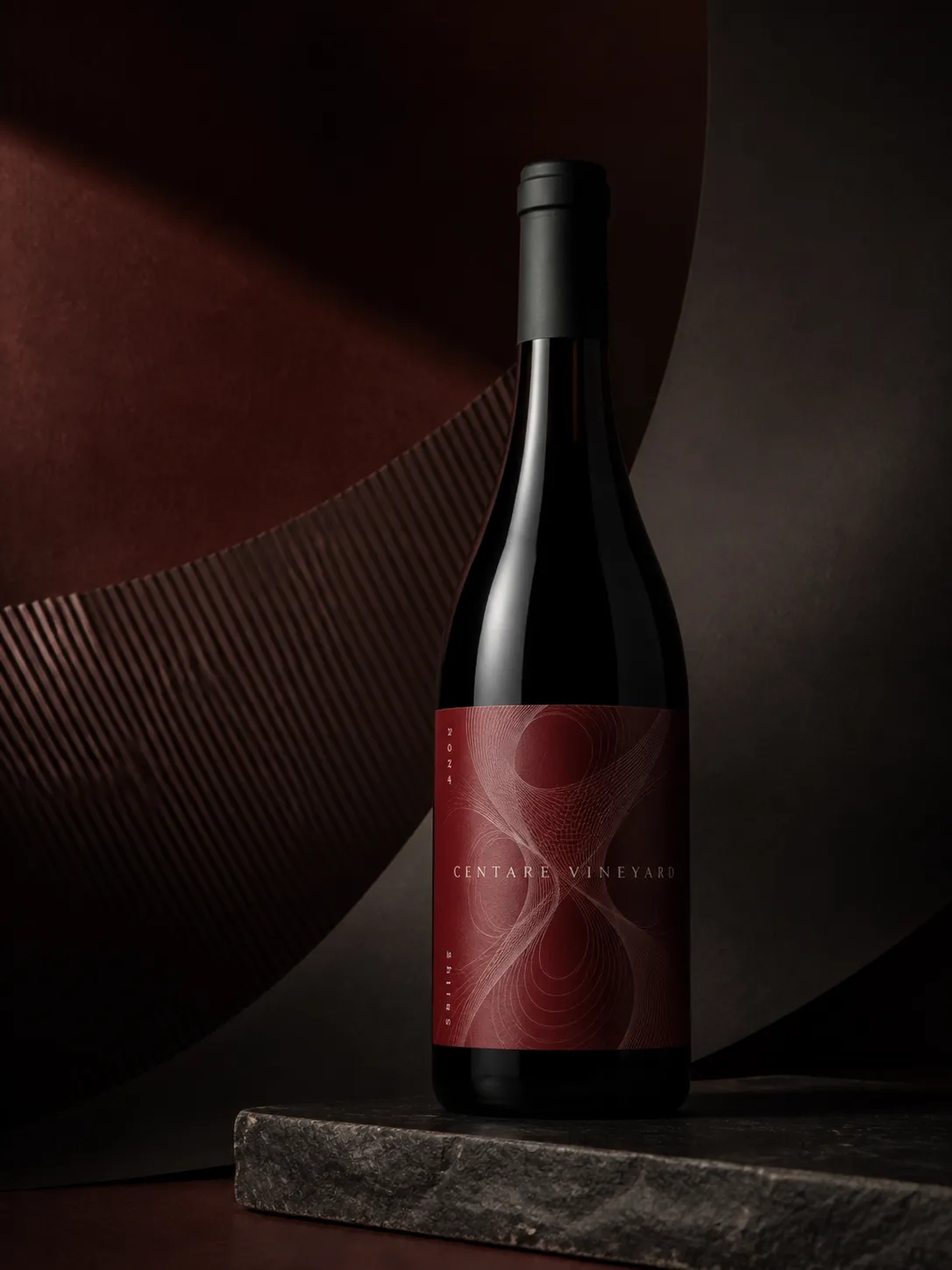 CENTARE Shiraz bottle in a deep red and charcoal abstract studio setting